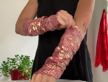 Load and play video in Gallery viewer, this is a product video: woman arms showing how to weare lamiadesign sleeves, lambskin leather print rectangle, gold, pink, purple lambskin sleeves
